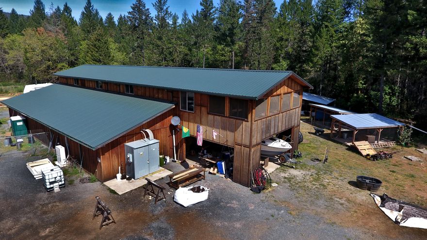 Southern Oregon's finest! Over 31 naturally stewarded acres.
with a 8,352 sq ft two story building.  
Huge downstairs space.
Upstairs there's a ½ bath, break area, office space. Security system and camera system. 

Home site approved.
25,000 Gallon rain catchment system provides irrigation.