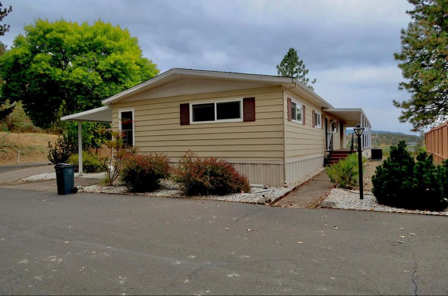 Amazing panoramic views of the Rogue Valley right from your private, spacious deck. This well maintained and move in ready home is one of a kind, and a must see. Located in the highly sought after Western Carriage Estates, 55+ community, just minutes from historic Jacksonville. Home is located on the top level of the park, and backs up to scenic hiking trails. Gas fireplace to make you feel cozy, and a large two car garage, with an attached carport for plenty of parking. Park amenities include a clubhouse, pool and a lot of activities like billiards, games, potlucks and various social gatherings. Space rent is $795 a month.
All information deemed reliable but not guaranteed.