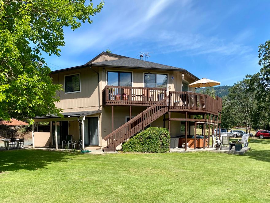 This 2594 sq-ft architectural delight sits on a rural park-like .75 acres and yet is close to town. Enjoy your morning coffee on the deck or hot tub overlooking a year-round creek with scenic mountain views. This well-maintained home has a 2-car attached garage, 3 bedrooms, 2 bath on the main floor with a finished basement that has 9-ft ceilings, kitchen, living room, 2 bedrooms, bathroom and a laundry room with a separate entrance that could make this perfect guest quarters or extra room for the family! There is a 378 sq-ft additional building with a loft, full bath & kitchen area that would make a great artist's room, additional guest quarters or whatever you dreamed it to be. This is truly a must-see house!