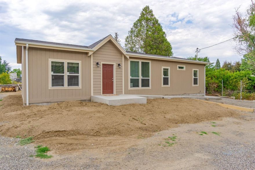 Gorgeously finished & never before lived in! Conveniently located between the cities of Phoenix and Medford, near shopping, schools, and both I-5 exits. Split floor plan with 3 bedrooms and 2 bathrooms. Two living areas with recessed ceilings with can lighting and great natural lighting from the many windows. Full wall built-in media center w/extensive shelves, stone accents, and space for all of your entertainment equipment. Kitchen features generously tiled backsplashes, a host of cabinets, matching Frigidaire appliances, and two-tier cooks island & eat-in bar. Master suite includes walk in closet and large bathroom with tasteful raised vanity w/over counter lights. Property is wheelchair accessible, with ramped concrete sidewalk wrapping fully around home from front door to back covered patio. Owners went the extra mile on the details while finishing this lovely home!