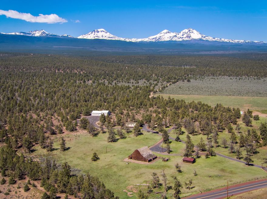 Golden Triangle location! Midway between Tumalo and Sisters, in the midst of hay and agriculture parcels, lies one of Central Oregon's first dairy farms, dating back to the early 1900's. A former cattle ranch, the property includes relatively flat 16.85 acres, a pond, an historic barn ready for restoration, a Saddle/Blacksmith house, detached garage, carport, 1568 SF 3 bed/2 bath manufactured home, 3000 SF shop with RV storage. Two add'l. RV pads complete with power and sewer. There is a beautiful flat building site on the west side of the property with full Cascade Mountain views. Historic farm equipment adorns the grounds. Gated and charming!