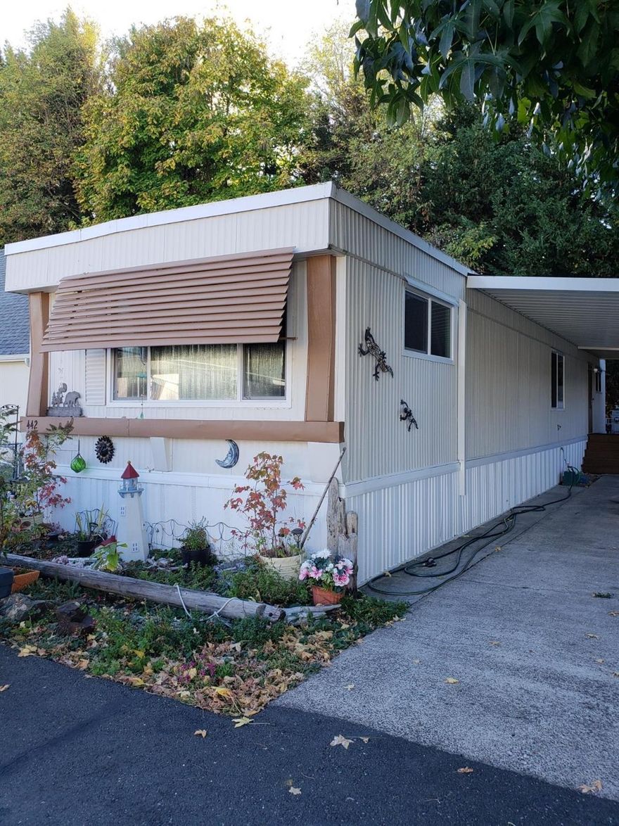 Like Nearly New. 1975 Extra wide Single-wide with New windows, roof, heat pump, plumbing & floor-ceiling-wall insulation. Fenced with shop.