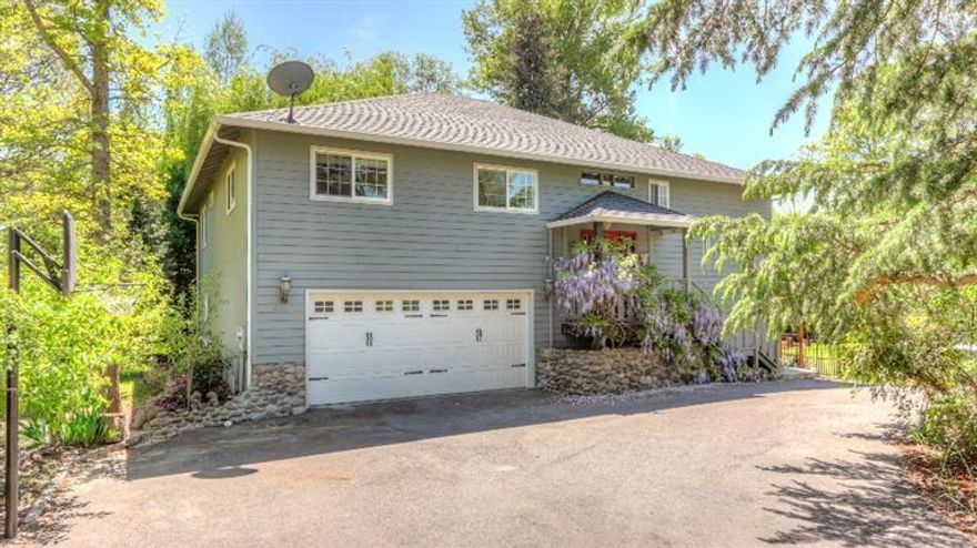 Situated on a 0.35 acre flag lot off the main street, this 3 bd. /3 ba. 1840 sq. ft. house has a front row seat on Little Butte Creek. Nature will surround you with several varieties of fruit trees, creek front and garden sitting areas plus easy care raised garden beds. This tranquil home has an open floor plan, soaking tub in the master, pantry in the spacious kitchen, and a composite deck off the living room. A custom rock encased certified wood stove will keep you warm and cozy on those chilly nights. A huge workshop in the full basement has several separate workrooms. Several of the workshop rooms have electricity, plumbing and insulation. This is a dream come true for a man cave, hobby enthusiast, or the person that has the need for extra storage. Kitchen appliances and irrigation equipment (from the creek) included in sale. Virtual tour viewing is a must.