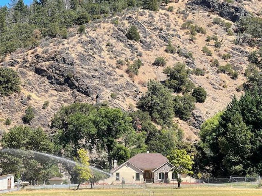 Luxurious Pagnini Custom Home on the Applegate River.  Situated Far from the Road for Optimum Privacy & Serenity.  Stunning River & Mountain Views.  Single Level, Dramatic Entry, Open & Thoughtful Floor Plan. Gourmet Kitchen w/Granite, Island, Double Ovens, Dacor Cooktop, Pantry & Abundance of Storage.  Dining Nook & Elegant Formal Dining Rm.  Family Rm has an Entertainment Center & Built Ins, Woodstove, Custom Coffered Ceiling & Fan.  Living Room Vaulted Ceilings & Gas Fireplace.  Oversized Primary w/Custom Coffered Ceiling, French Door w/Patio Access, Large Bath w/Jetted Tub, Walk in Closet & Granite Counters. 2nd Primary w/Built Ins, Sliding Glass Closets.  Oversized Laundry. Doug Fir Cabinets, Slate & Hardwood Floors w/Granite Inlays, Storage Galore.  Irrigated Acreage.  Wonderful Horse Property with Trails Directly Across the Street.  Property Suitable for Ranch or Farming.  Unique Micro Climate. Excellent Solar Exposure.  Sophisticated Domestic Water Filtration.