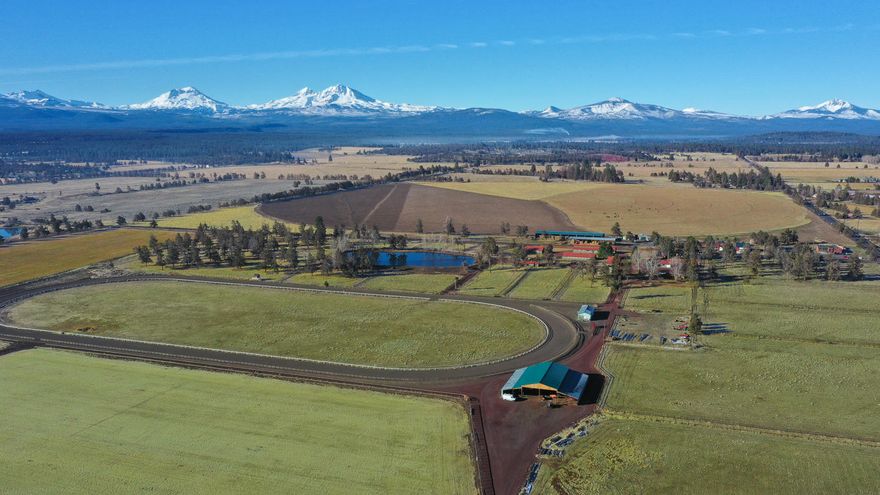 This property was the original training grounds of  Historic Tumalo Farms which is rich in history with a unique story. It is comprised of 78 acres of serene farmland with a pressurized irrigation system in the outskirts of the vibrant community of Sisters . Positioned with direct views of the towering Cascades, Tumalo Farms is perfect for one seeking privacy enveloped in 360 degrees of majestic landscape with multiple outbuildings including 12 and 20 stall barns, a hospital barn, hay barn, detached office/shop, manager's house, multiple paddocks and a training race track. Grow your own crop or lease to a custom farmer with 63 acres of pasture and orchard grass. Sisters is a charming town hosting a mix of restaurants, shopping and loads of outdoor activities. Whether you are looking for a ready made equestrian farm to escape the crowds or searching for the ideal spot to build your dream home, Tumalo Farms won't disappoint. Isn't this the year to escape the crowds and return to nature.