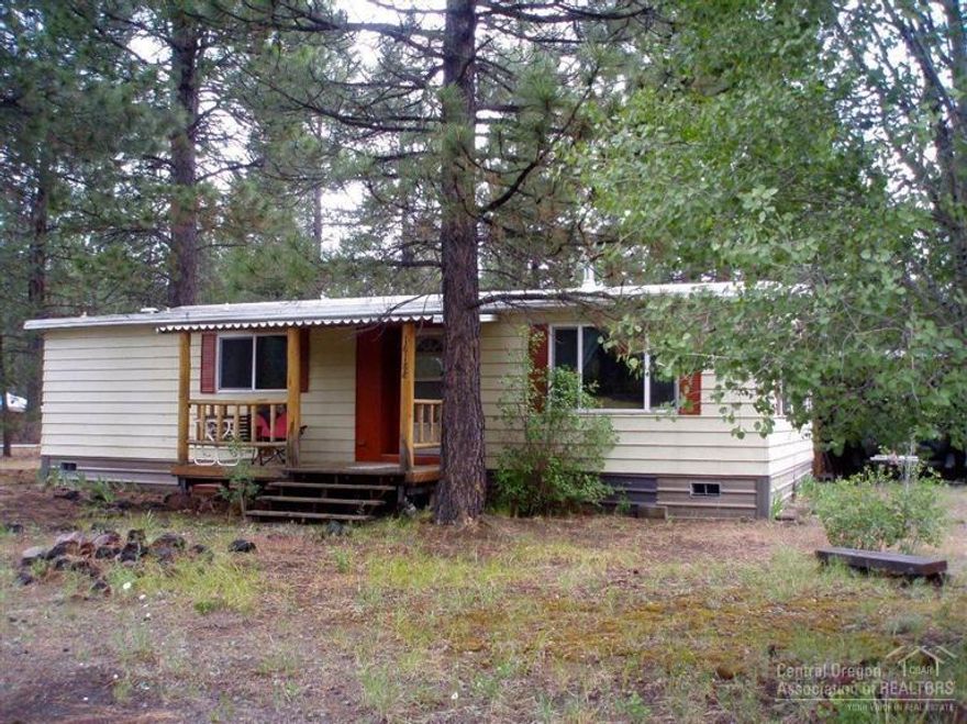 Property backs State land and a half mile from the state Park! Private fenced yard with Ponderosa Pines, circular driveway, RV parking and full hook-ups, certified wood stove, double carport, covered front and back porches, new laminate floor in kitchen and it comes furnished. The perfect get away from home!