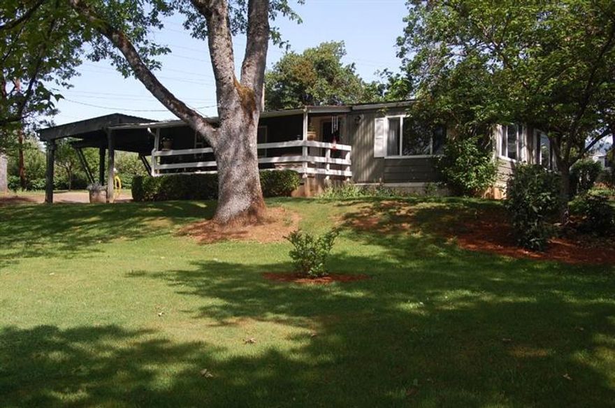 Absolutely beautiful setting close to Grants Pass shopping centers. The home is shaded by the wonderful old growth trees on the 1.05 acres of landscaped property. One side of the property is fenced for animals with a small poll barn enclosed on 3 sides for hay and such. You'll find a variety of fruit trees; apple, peach, and plum. Above ground garden area. The home features 2 bedrooms, 2 baths, spacious living room, dining room with built-in hutch and a nice kitchen. All the appliances are included, even the washer & dryer.