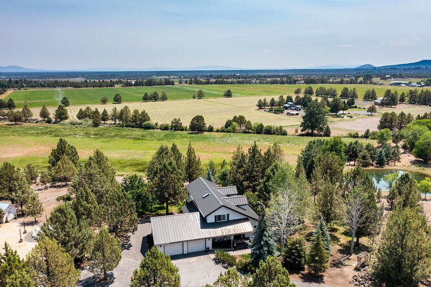 Get ready to be charmed by this 15-acre Tumalo property nestled in country paradise. Spend your summers swimming in the pond, picking fresh fruit off the trees, and enjoying farm-fresh eggs from your very own chicken coop. With a full RV Hook-Up, 2100+ sq ft hay barn, 6 acres of irrigation, a greenhouse, and chicken coop...the possibilities are endless. Bring your horses, cows, or alpacas to graze on your irrigated pasture. The recently updated home features the Master on the main level, three additional bedrooms (one downstairs, 2 upstairs), 2.5 baths, a mudroom, a laundry room, and a loft that would make for the perfect office, playroom, or family room. In the main living area, you will find vaulted wood ceilings, pastoral views, and an abundance of natural light. The large open kitchen has hickory cabinets, granite countertops, and a subzero refrigerator. This home is a hidden gem and provides a bounty of privacy while only being minutes outside of Bend.