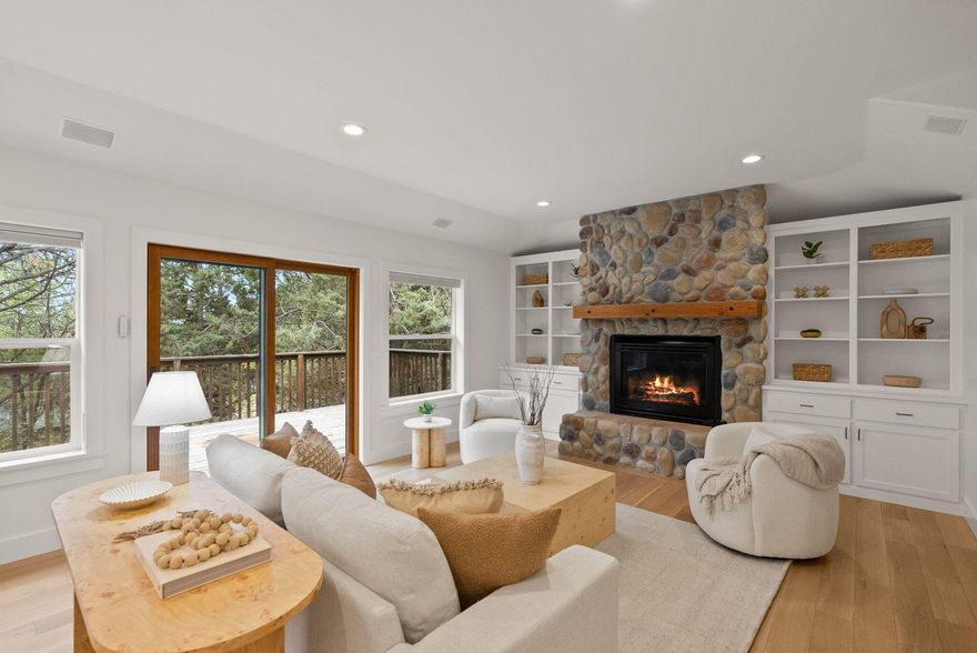 Tucked into one of NW Bend's most sought-after neighborhoods, this bright, beautifully updated home is full of surprises. Upstairs, soak up natural light, cozy up by one of two fireplaces, and enjoy stylish new engineered hardwood floors and a dreamy remodeled kitchen with fresh appliances. Two living areas and an office offer room to spread out. Downstairs, discover two bonus rooms (not in sq ft), including one with a roll-up door—perfect for bikes, art, gear, or your next big idea. Outside, relax on two decks, explore the spacious backyard, and take advantage of massive under-house storage. This home is just minutes from parks, the river, downtown fun, and neighborhood tennis courts. Come see where your next adventure begins!