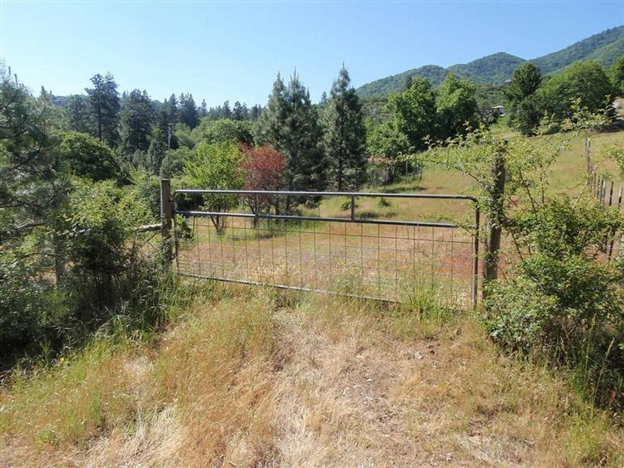 Beautiful five acre lot, in the County, yet just on the outskirts of the City. Wonderful assortment of terrain including gentle sloping pastoral lands, mature forest ravine with seasonal creek, gardens and views. The shared drive is paved, well and septic are in, there's power to the building site, shed, partially fenced, the list goes on. This will be a great place to build your dream home with a very convenient close-in location.