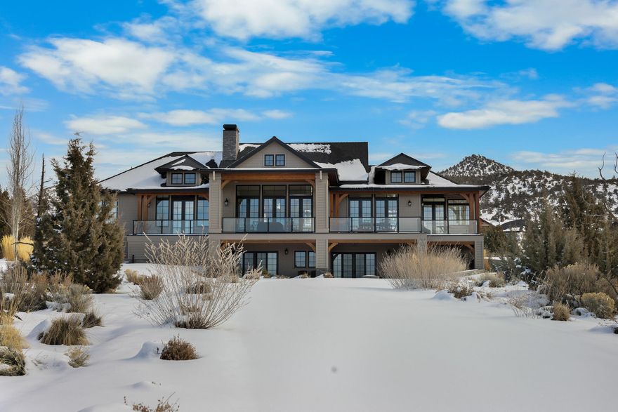 If you've wished for a contemporary French Country interior wrapped in a truly Brasada Ranch exterior, this gift is for you. Elevated homesite next to the 13th fairway of Brasada Canyons golf course, elegant interiors capture surrounding Cascade Mountain vistas. White-washed wide plank floors & custom cabinets, white walls & tile with a soothing neutral color pallet grace the entire home. Open kitchen features vaulted ceilings, quartz kitchen island & tile, Viking appliances, farm sink, & banquette. Expansive adjoining great room with dining & sitting areas with gas fireplace opens to large, covered deck with pavers. Primary bedroom on same floor with pass-through fireplace, vaulted ceilings, & grand en-suite bathroom featuring raised tub, walk-in closets, & private lav. Downstairs: two guest rooms with two full baths, built-in bunk beds, & entertainment area with wet bar. Large mud room with elevated tiled dog wash, half-bath, & laundry area. Detached three-car garage. Landscaped