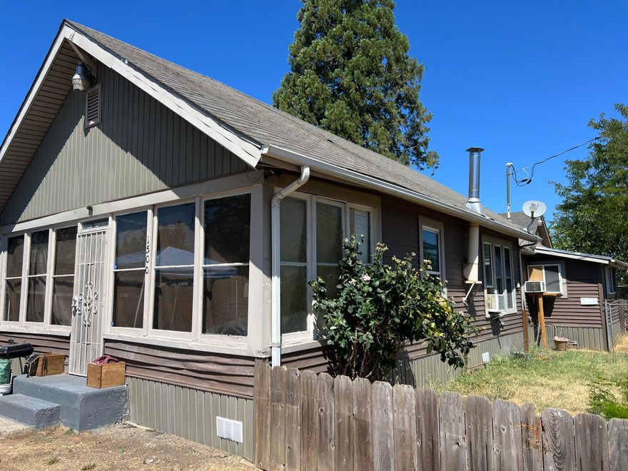 ATTN: Investors, First Time Homebuyers & Contractors - unlock the full potential of this 1920 home on a corner lot in West Medford. Current home is 1,021 sq feet with 3 bedrooms, 1 bathroom and a detached 1-car garage. Fenced front yard, plenty of parking and a charming enclosed front patio. Current owner has updated flooring, painted and updated the bathroom. Potential to build a multi-family property (buyer to do their own due diligence).