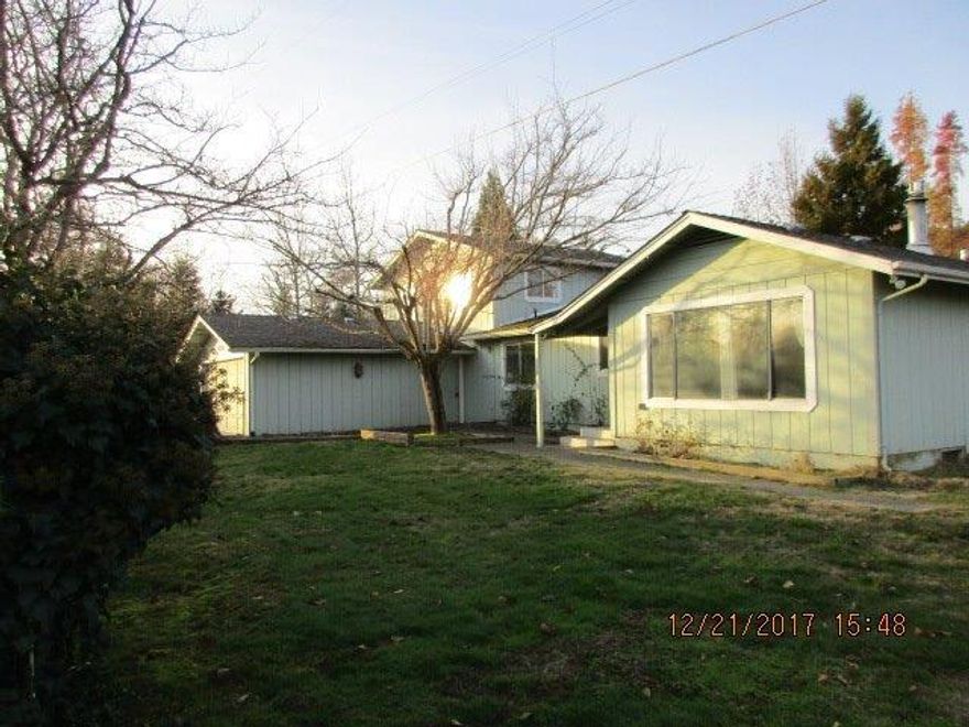 This hard to find four bedroom home offers great potential. Two bedrooms including master bedroom with half bathroom on the main level. Two more bedrooms upstairs with a full bathroom. Nice size garage with an attached shop area. Large fenced corner lot with garden shed. All this and located in a convenient Grants Pass location. Employees and family members residing with employees of JPMorgan Chase Bank, N.A, its affiliates or subsidiaries are strictly prohibited from directly or indirectly purchasing any property owned by JPMorgan Chase Bank, N.A.