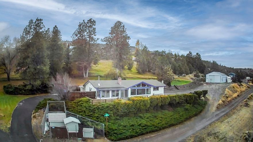 This is the perfect setup for living, working, and creating—all in one place. This irrigated, 2.32-acre property has panoramic views of the Cascade Mountains and valley with plenty of room to grow. 

The 24x36 insulated, climate-controlled shop is ready for your business or projects, with two 200-amp panels, multiple workrooms, offices, a bathroom, and a loft living area. Also part of the shop is a 480 sf stable. 

The updated home features vaulted living spaces, a sunroom, and large redwood deck with amazing views. The remodeled kitchen has hickory cabinets, granite counters, new stainless appliances, and walk-in pantry. Bathrooms are refreshed with new cabinets, granite counters. The flexible, fully insulated media room can also work as an office, guest room, or suite. A big laundry/mudroom adds storage and workspace. 15 years remain on the roof warranty; heat pump was installed 2/22. 
SOLD AS IS

This is a rare chance to build your lifestyle and business in one peaceful spot