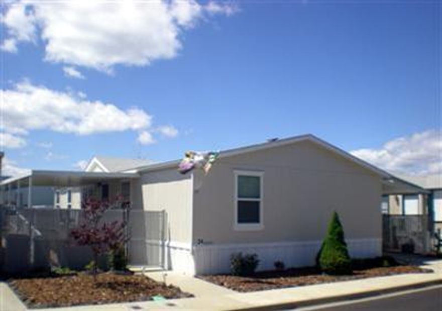 First class home in a Class A park. Excellent condition with vaulted/high ceilings throughout. Large master with deep soaking tub and separate shower. Open floor plan with office /den or 4th bedroom. Large kitchen with island and lots of storage. Big utility room. Over $15,000 in recent upgrades: new 24 x 12 covered patio with trex decking and ramp, new exterior paint, new landscaping, new fixtures and cabinets, new storm doors. Large two car carport. Two big storage sheds. Beautiful yard with timed sprinklers. Pride of ownership throughout. A must see!