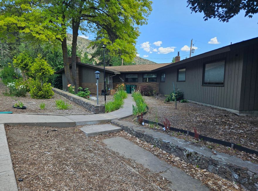 Tucked away in the Hot Springs area just off of Pacific Terrace you will find this mid-century home with much of it's original charm.  This home features living space on one end and bedrooms and bathrooms on the other end.  New LVP flooring plus a new dishwasher. The basement features plenty of space with a half bath, laundry room, an exterior door to a smaller private deck and the garage.  The bathrooms have their original mid-century bathtubs,, sinks and tile for a fun retro theme.  The large kitchen features an island and breakfast bar with plenty of counter space and a large pantry.  If you are looking for a mini orchard and a serene backyard you may just fall in love with this one.  Cherry, Peach and Apple trees, in ground sprinklers in the front and back yards, fenced and very private.back deck with a landscaped front yard with plenty of perenial flowers to add a splash of color at different times of the year. Quiet yet still close to schools shopping and hospital.