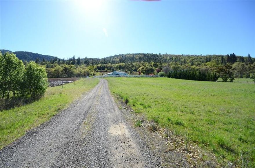 Custom built for owner by Mike Pagnini construction. Large bedrooms plus office or could be a bedroom. Hardwood floors almost throughout home. Large island in kitchen opens to large great room and dining room with built in buffet, china hutch. Solid oak doors, large windows to take in the views. Gated entry and white fences. 3 car finished insulated garage with work area, separate storage room and 1/2 bath that is heated and cooled. Just outside of downtown Ashland with 3.89 acres plus TID irrigation rights for approx. 1.5 acres. Great well per seller. Nice patio areas off back of home and off dining and living room. Solar hot water plus a solar electric along with regular electricity for this nice custom home. This could be the perfect mini ranch set up or just enjoy the land and views of mountains.