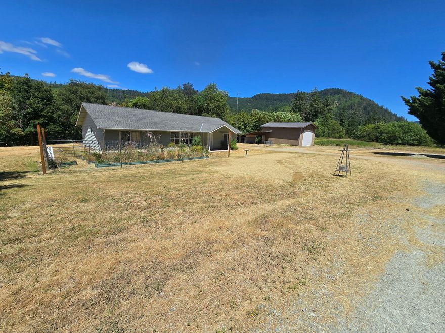 Welcome to 2157 Ferguson Lane in Days Creek, Oregon—a premier riverfront horse property offering scenic beauty, privacy, and exceptional versatility. Set on two tax lots along the South Umpqua River, this picturesque retreat features fenced pastures perfect for horses or livestock, creating an ideal setup for equestrian living or a hobby farm. The well-maintained home offers charm and comfort, while the expansive grounds provide room to expand, garden and greenhouse, or simply enjoy the outdoors. A large garage shop offers generous space for storing equipment, vehicles, and recreational toys, making it perfect for those who value both function and freedom. Whether you're seeking a full-time rural lifestyle or a peaceful weekend riverfront escape, this property delivers with open space, river access, and unmatched potential. Don't miss this rare opportunity to own a slice of Oregon's natural beauty with room to live, grow, and explore—schedule your private showing today.