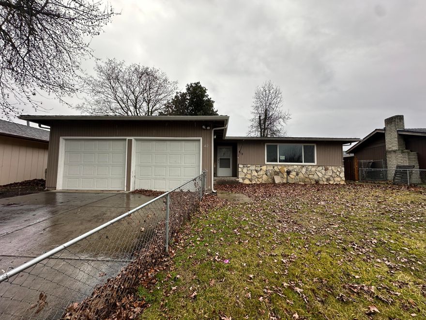 3 bed, 2 bath home on a spacious .15-acre lot just minutes from town. Embrace the warmth of a cozy living spaces and a well-appointed kitchen. Enjoy outdoor living with a fenced front and backyard, complete with a shed and garage for additional storage.