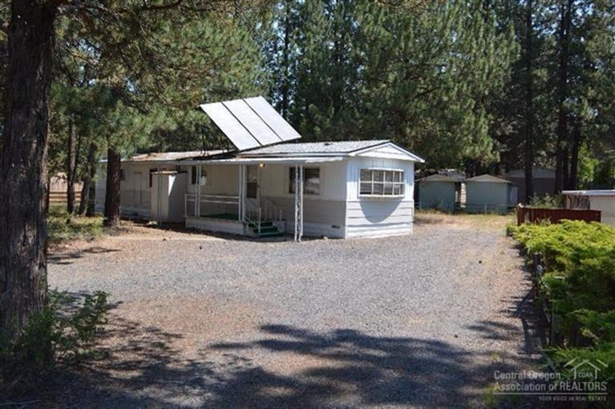 GREAT BUY! Clean and tidy manufactured home on nearly 1/2 acre at the end of quiet cul-de-sac close in SW Bend. Fresh carpet and paint, newer roof, oversized detached garage with shop space, small out building, solar hot water, nicely treed lot. Move-in ready!