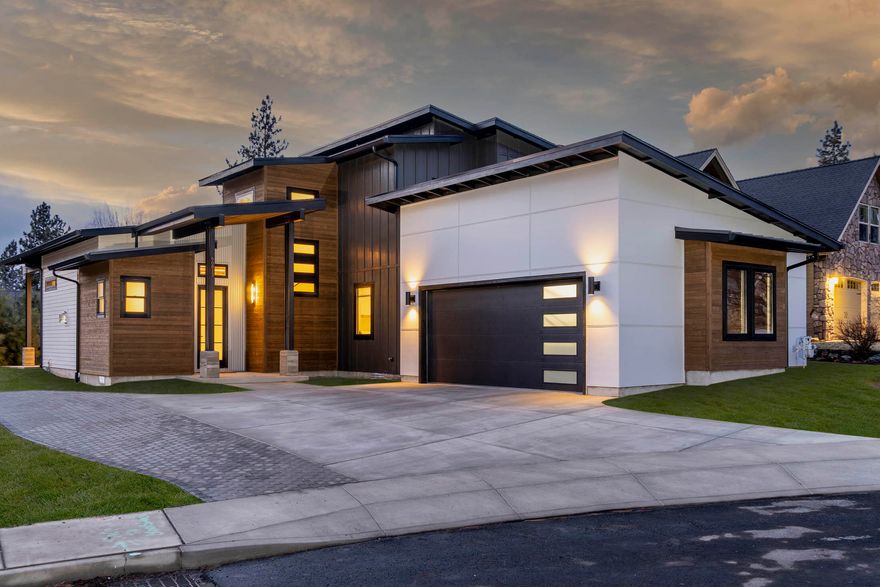 ** Winner Best Architectural Design & Best Kitchen in its category. **
 In a quiet and established neighborhood, this custom built 2020 home is a must see. Thoughtfully selected materials blend perfectly to give texture and character to this contemporary home with rustic touches. 

 Features too many to list but include integrated steel posts and reclaimed wood beams, custom designed 8' doors, whole house sound system, central vac system, and a custom designed geometric metal screen at the entrance. 
Open living area with a gas fireplace and brick feature wall with built-in cabinets. The living space can extend to the outdoors through the 10' wide opening with moveable glass panels to a back patio with fireplace table.
Flexible Bonus room with ADA bath and  own entrance ideal for separate living quarters.