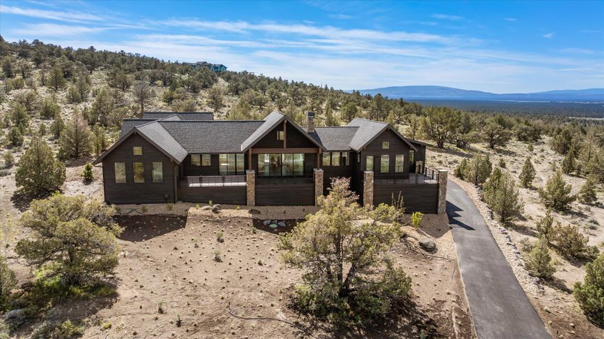 Refined single-story new construction in the Eastside Highlands at Brasada Ranch! Enjoy stunning panoramic Cascade Mountain views from the large and spacious deck—ideal for outdoor entertaining or quiet mornings. Inside, the open floor plan is bathed in natural light and features custom built-ins, hardwood floors, vaulted ceilings, and a striking floor-to-ceiling stone fireplace in the Great Room. The chef's kitchen showcases a large granite island, stainless steel appliances, walk-in pantry, and abundant cabinetry. The luxurious primary suite offers mountain views, a walk-in closet, dual vanities, a soaking tub, floor-to-ceiling tiled shower, and direct access to the private deck. Two additional bedrooms, a full bath, versatile bonus room (ideal for an office or 4th bedroom), a spacious laundry room with storage, and a finished 3-bay garage complete this move-in-ready home in one of Central Oregon's most sought-after resort communities.