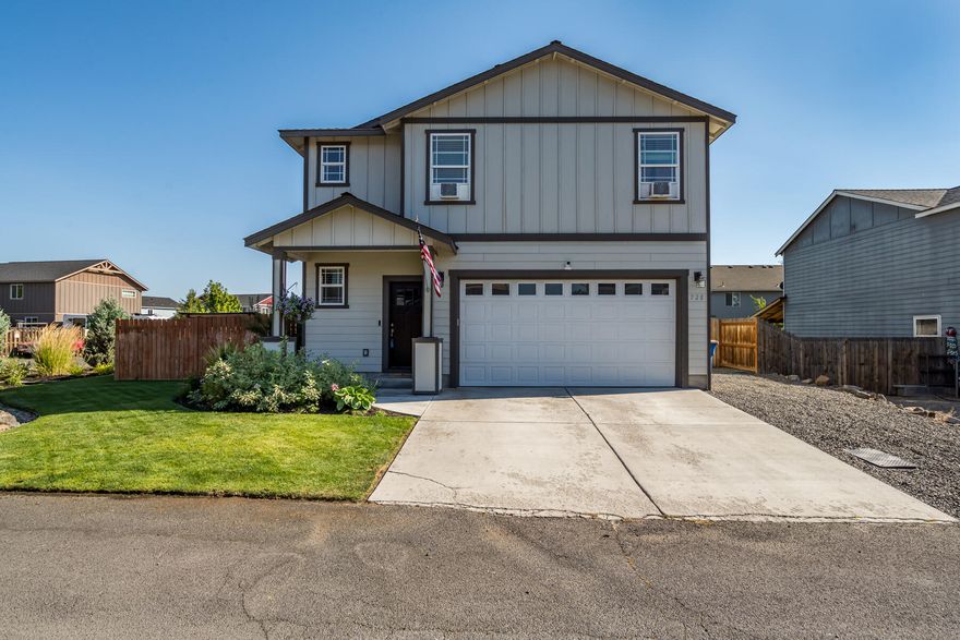 This charming Redmond home is located on a 0.16-acre corner lot in a quiet community, just a block from Diamond Bar Ranch Park. An open floor plan features high-quality LVP flooring, a spacious living room with a gas fireplace, and a kitchen with stainless steel appliances, sleek black granite countertops, and a breakfast bar. Upstairs includes three bedrooms and two bathrooms, with a convenient powder room downstairs for guests. In the primary bedroom suite, LVP flooring complements a dual vanity with granite countertops and a deep walk-in closet. A generous fenced and beautifully landscaped lot offers flexible outdoor living with a back patio, a pavered outdoor dining area, and a large side yard with raised garden beds. Along with the main driveway, a side gravel pad and two-car garage provide ample parking and storage. Ideally located just over a mile to St. Charles Redmond and less than three miles to downtown, with easy access to Highway 97 to Bend.