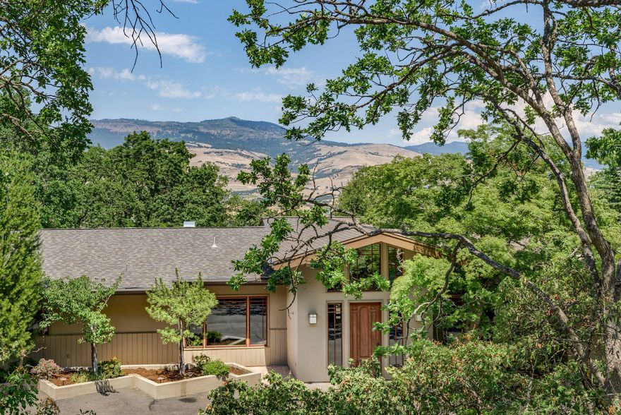 Rare Ashland opportunity! Breathtaking mid-century estate on over 4 irrigated acres inside the city limits. The vaulted great room invites you into the heart of the home and boasts wide plank Cherry floors, oversized wood burning fireplace with detailed stone surround & convenient access to the gourmet kitchen complete w/ rainforest marble counters & backsplash, Dacor & SubZero appliances, operable skylights & walk-in pantry.  You will enjoy the views of Grizzly Peak from the living areas and the outdoors. The house is complete with a wet bar, formal & informal dining. Main level master with spa like bathroom including a steam shower and jetted tub.  Several en-suite bedrooms, a library or home office w/ fireplace, lower level family room with built-in entertainment center. 3 car attached garage w/ 1 bed, 1 bath guest apartment overtop. In-ground pool, Koi pond with cascading water feature. Stone paths and walls highlight the mature landscaping. City water & sewer, high speed internet.