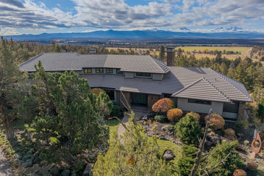 This exceptional home was constructed by Norman Building & Design, showcasing the finest craftsmanship & luxury finishes, from maple floors to custom birdseye maple cabinetry & expansive windows overlooking the Cascade Range. The main floor primary suite is a private haven w/ awe-inspiring views, a soaking tub, a generous walk-in closet & access to a secluded patio w/a hot tub. 3 additional en-suite bedrooms all w/ daybeds offer ample space & comfort for guests. Open concept kitchen, dining, wine refrigerator, mudroom, office area, luxury utility room & 2 living areas are just a few of the amenities that make this home special! Step outside to a serene outdoor living space, complete w/ a water feature that sets the perfect ambiance for lounging & entertaining. A 3-car garage serves the home, while a detached shop w/ a full bath provides versatile space, ideal studio or workspace. This home offers upscale living & is a must see property!