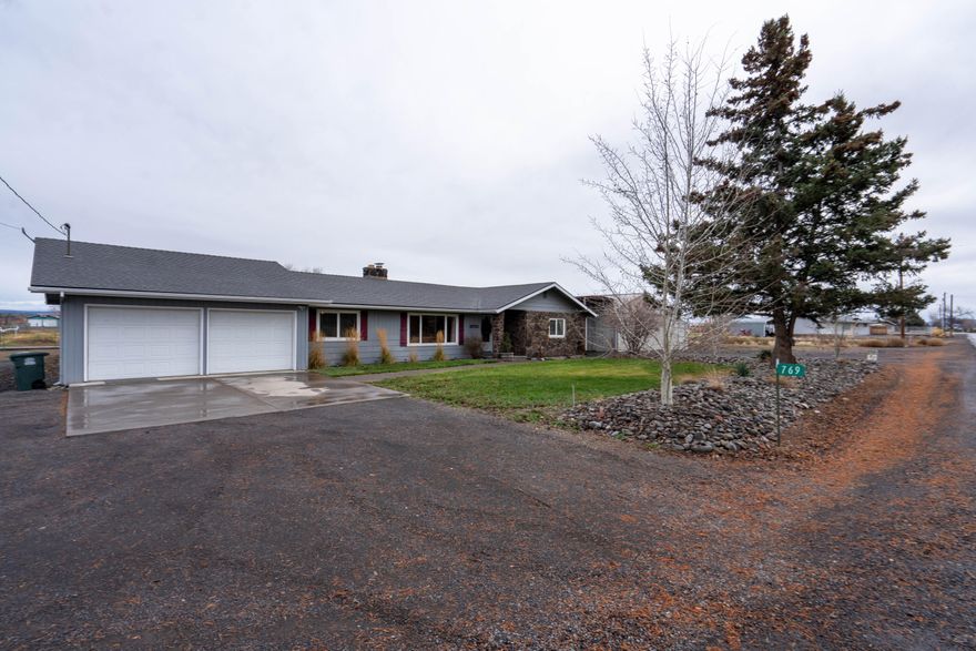 Discover serenity in this spacious single-story home w/1.1-acres of irrigation and set-up for multigenerational living! Home features a family room as well as an open living room space w/pellet stove plus the large country kitchen showcases stainless appliances and a pantry. Though all bedrooms are oversized, the main has a large bathroom and walk-in closet. Overall home has updated fixtures, paint, flooring, windows and a newer roof. Additional amenities include central AC, finished 2-car garage, long RV carport parking and an expansive trex deck ideal for entertaining. Nicely landscaped in front and back w/mature trees and lawn area as well as 8 fruit trees including peaches, cherry, apple and pear. The 30'x40' detached shop w/concrete floor and power as well as an attached enclosed machine shed w/equipment storage is a highlight of this property! Bring your animals - fenced-in pasture w/irrigation. This horse haven is close to Willow Creek Canyon trail for riding, hiking and biking