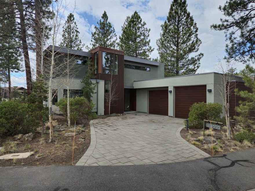 Located in the desirable Shevlin Commons westside neighborhood, this modern, green home melds with the natural character of the site and surrounding park lands. Designed by local architect, Erik Oldham and built by Woodcraft Environmental Builders, the well thought out floorplan focuses on function and livability. A jewel box of artistic details soften the modern lines. Beautiful interior finishes include 11.5 ft ceiling of exposed double beams, Douglas fir cabinetry, rift cut white oak floors, pellet fireplace, quartz and granite counter tops, well appointed kitchen with walk-in pantry, Shoji style sliding doors, cable lighting and clerestory windows offering an abundant light filled living space.