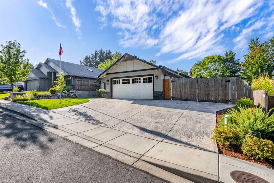 Just a few minutes from Hospital, Grants Pass Golf Course, and shopping, you will find 231 Sand Canyon Lane. The 2021 built home is 1884 sq ft, Single Level, and offers 3 bedrooms & 2 bathrooms. Home features granite counter tops, concrete siding, stainless appliances, gas fireplace with natural stone, superior alder cabinets, food pantry, vaulted ceilings in living and primary bedroom, and RV Parking with dump and electrical hook ups. The backyard is private, well manicured, has room for garden beds, and has a covered concrete patio to lounge and BBQ on. Short cul-de-sac streets, lends to low traffic location. Definitely a home to tour, see the quality and convenience of the home and its location.