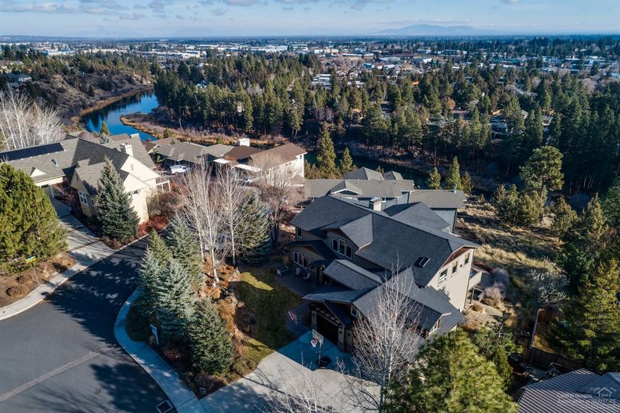 What a Value! Beautiful custom home above the Deschutes w/amazing city views on almost 1/2ac close to river trail. Open floorplan w/spacious greatroom featuring 20ft rock fireplace & soaring ceilings w/many windows to take in views. Gourmet kitchen w/3 ovens, 2 dishwashers, wine fridge, 2 sinks & chefs pantry w/ample cabinets & lovely granite counters. Home has top notch wood doors, game room w/fireplace & wet bar. Master suite approx 800sf w/cozy gas fireplace, lots of windows, retreat room, great for work-out space or office & an elegant bathroom loaded w/tile & jetted tub. 3-car garage, water feature, sprinkler system, mature landscaping & large outdoor living area-great for entertaining! Home abounds w/extras & close-in downtown location is hard to beat! Large game room on main level would make beautiful 2nd Master. Basement would make great ADU w/own entrance. Buyer to do due diligence on all aspects regarding ADU. Seller will look at all reasonable offers.