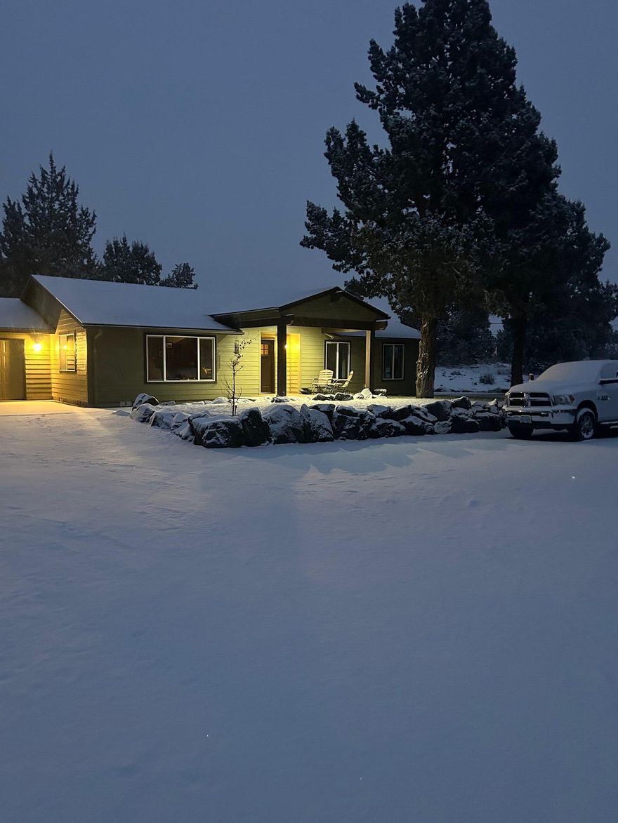 Welcome home! Watch the sunrise on your back patio with a view of Smith Rock and watch the sunset from your front patio with views of the Cascades. This a very well maintained 4.61 acres, fully fenced with small animal wire and electric dog wire (for the diggers) around the entire 4.61 acres, dog collar included. A well-insulated 24x36 pole barn/shop and an additional 20x20 metal shop insulated with rigid insulation. Landscaped with rock walls and railroad borders with timed irrigation. Backyard provides a great entertainment area with privacy. Horseshoe pits and plenty of room for corn hole boards, all surrounded by exterior lighting. Covered patio with a space for your TV and surround sound. Pre-wired for a hot tub. Private well and septic system. This ranch style 3-bedroom 2-bath home is well kept. New windows, roof, and exterior paint last year. Heat pump was installed in 2019. The interior is painted with neutral colors. This home is truly move in ready. Come check it out.