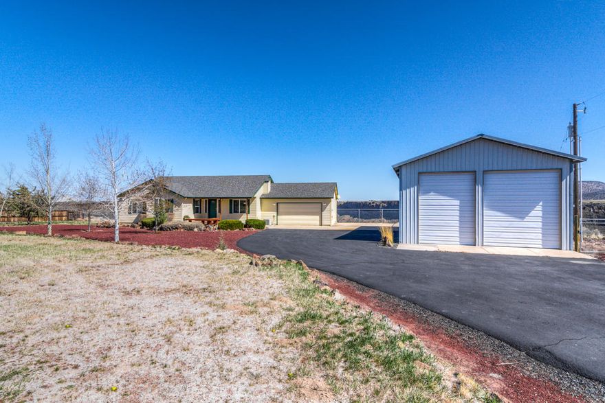 Picturesque views from this light and bright single level home located in Crooked River Ranch situated on the rim! This thoughtful floor plan with open great room facing panoramic views will welcome you home each day. Light and bright kitchen features quartz countertops, white cabinets and stainless steel appliances including a propane gas range. Large breakfast bar adds to seating along with cozy breakfast nook with those big view. Bathrooms were recently remodeled with new paint, flooring, dual flush water closets and quartz countertops. Great room opens to beautiful deck with room for seating, BBQ's and entertaining. Paved driveway leads to gated and fenced including shop. Shop or RV garage is 30' x 40' with two 14' rollup doors. If you are looking for over an acre of room to call home you need to call your agent and see all this property offers. Well maintained and move in ready!
