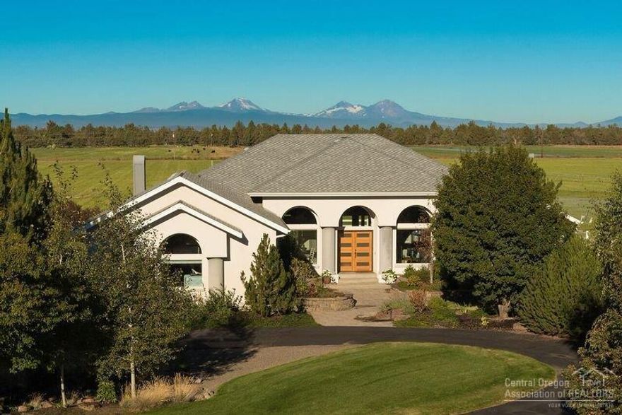 Equestrian Estate surrounded by white vinyl fencing & orchard grass pastures. Formal living & dining, open concept kitchen w/quartz counters and SS appliances & family room w/fireplace. Covered patio for outdoor entertaining. Oversized windows w/picturesque views of the Cascade Mountains from almost every room. 30X60 shop, 60X62 barn w/4 stalls, 80X85 covered riding arena + outdoor arena. Ten minutes to Badlands Wilderness for trail riding or Brasada Equestrian Center. Who said you can't have it all?