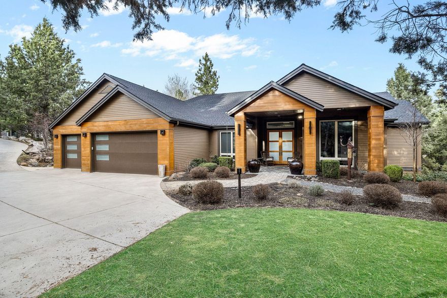 Experience the perfect blend of modern and traditional in this stunning contemporary home. Boasting an open floor plan, the main level features elegant wall-to-wall windows that showcase views of Smith Rock. Relax in the spacious living area with a cozy gas fireplace, or cook up a storm in the kitchen, complete with cutting-edge details and amenities. The luxurious primary bedroom includes a serene sitting area with a view and its own gas fireplace for ultimate comfort. Two en-suite guest rooms offer privacy on the opposite side of the house.The versatile lower level adds valuable living space that opens up to a spacious, tranquil backyard. A private flex space is ideal for use as an artist studio, mother-in-law suite, or workout haven. The neighborhood complements this serene park-like setting, offering privacy, tranquility, and close proximity to hiking trails and local attractions. A heated driveway is convenient during winter.