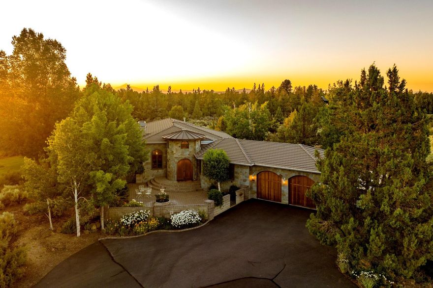 Easy to care for Horse Property/Hobby Farm on 19 private acres w/7.48 acres of
irrigation on a private cul-de-sac in NE Bend. 
 Single level, European-inspired home blends modern elegance with Old World charm and features a Telluride stone exterior and exquisite design elements including arched windows, concrete and rough-hewn flooring,
Travertine finishes and stone accents. Stunning foyer enters into a Great Room with
soaring ceilings, fireplace and dining area. Spacious Gourmet kitchen was remodeled by Neil Kelly in 2014 and features high end appliances, custom cabinets and luxury granite. Family room with built ins, gas fireplace and sliders that lead to a beautifully landscaped backyard, sparkling pool and hot tub. Primary Suite has a Luxury Bath with jetted tub and huge walk-in closet. Two guest suites share a bath. Large barn/shop with covered RV spaces and an unfinished loft. Two Fenced pastures.  Fabulous
location close to hospital, shops, amenities and wonderful schools!