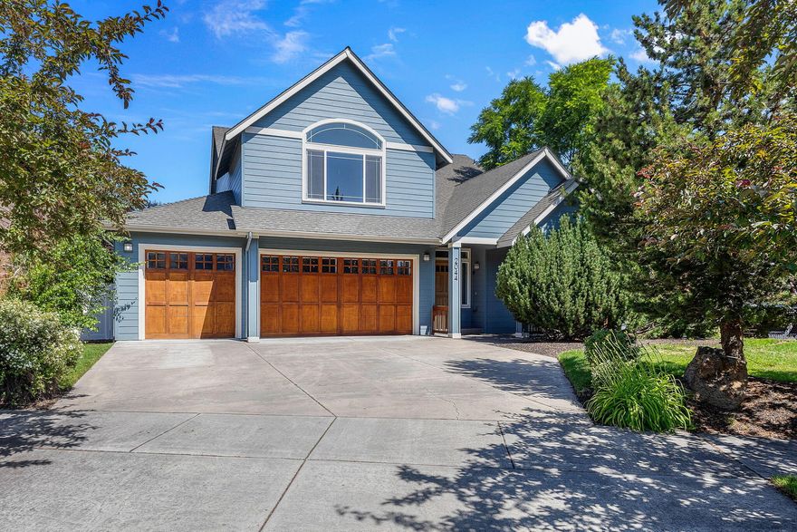 Welcome to one of Bend's best kept secrets. Nestled in and amongst quiet and established neighborhoods, you will find this beautiful 4 bedroom, 3 full bath family home. Hardwood floors throughout Once inside you will immediately notice a generous entry hall with slate tile and vaulted ceilings. On the right through glass french doors is a great flex space with potential for a formal living area, dining room, or office/library. Head on into the open concept great room, with a gas fireplace, wet bar and a large wall of big windows. Entertainment is easy with an open concept kitchen with stainless steel appliances and a dining room. On the main floor you will find one of four bedrooms with access to the patio in addition to a full bath and laundry room. Upstairs is a bonus room and or additional Primary bedroom and 2 additional bedrooms with lots of natural light. There is a full bath that is accessible from the bonus room or the upstairs walk. Private mature, tree line, fenced back yard