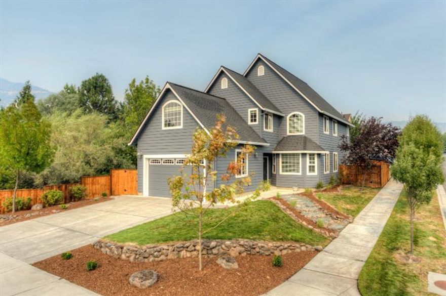 Versatile floor plan in sought after East Medford Neighborhood on a choice corner lot. Plenty of natural light throughout. Open floor plan with granite counters and plenty of storage in the kitchen. Stunning re-finished wood flooring through the majority of the main floor. Two living areas downstairs plus a large bonus room upstairs, makes this home perfect for all your entertaining needs. Large master suite with walk-in closet, jetted tub, granite counters and dual vanity sinks. New exterior and interior paint plus fresh landscaping. The home borders Lazy creek and is situated on .26 acres. Two car finished attached garage and plenty of off street parking