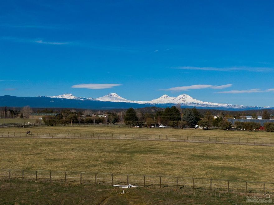 Enjoy stellar Cascade Mtn views from nearly 20 acres of amazing Tumalo property. Zoned EFU & backs to BLM with 10 acres of Tumalo irrigation rights. Perfect place to build your dream home & hobby farm. Horse friendly area w/miles of trails out your back gate. The Deschutes River is just minutes away w/world class fishing & rafting. Property hosts a 2000 model 3 bedroom, 2 bath manufactured home that's neat & clean w/laminate flooring in the main living space. An original homestead is currently used as storage but could be rehabbed into a chic farmhouse. Opportunity to stay & enjoy the property while you build - this is your opportunity to own your own piece of Central Oregon! New no climb horse fencing w/top rail just installed, irrigation is being improved & all the clean up is done. Located just outside of Tumalo & a short drive to Bend, Redmond or Sisters... in the golden Central Or triangle!