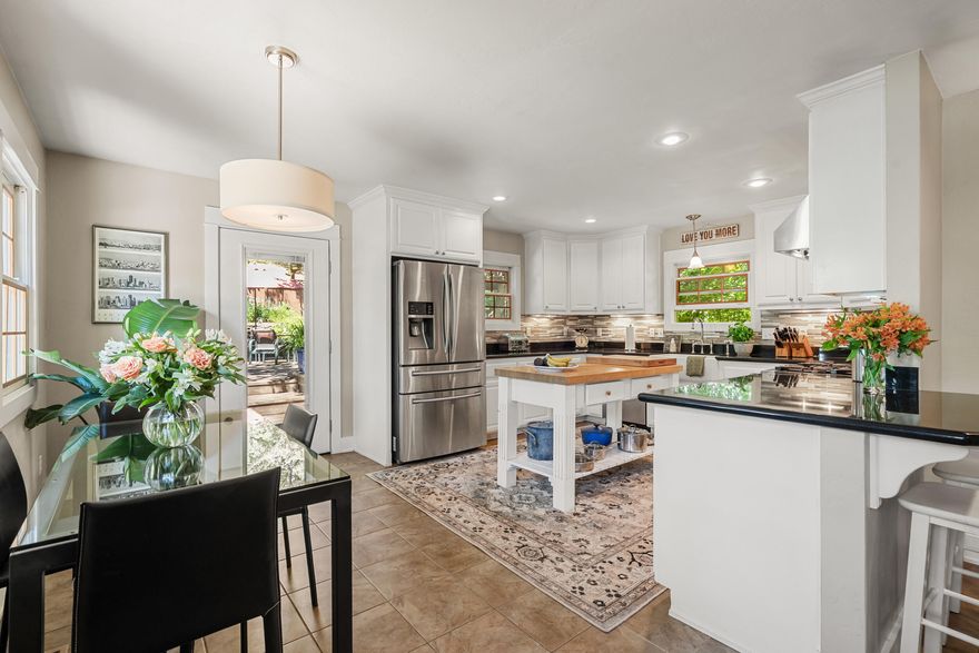 Do you love historic charm paired with modern comfort? This beautifully renovated 1889 home on the Historic Register offers the best of both worlds. Originally a small single-level, it was transformed in 2001 into a spacious two-story that retains its original character. The main level features two bedrooms, a full bath with clawfoot tub, cozy living room, laundry, and a large kitchen with farm sink, Wolf range, and Bosch dishwasher. Upstairs you'll find a 3rd bedroom, full bath, and a large primary suite with walk-in closet and spa-like bath with soaking tub and shower. Set on a private, professionally landscaped .37-acre lot with two water features, a fenced garden, and a century-old apple tree with tree fort, this home is perfect for year-round living and entertaining. With timeless design, tall ceilings, double-pane windows, a new HVAC system, and a recent appraisal at $795,000, this is a rare opportunity to own a piece of history updated for today.