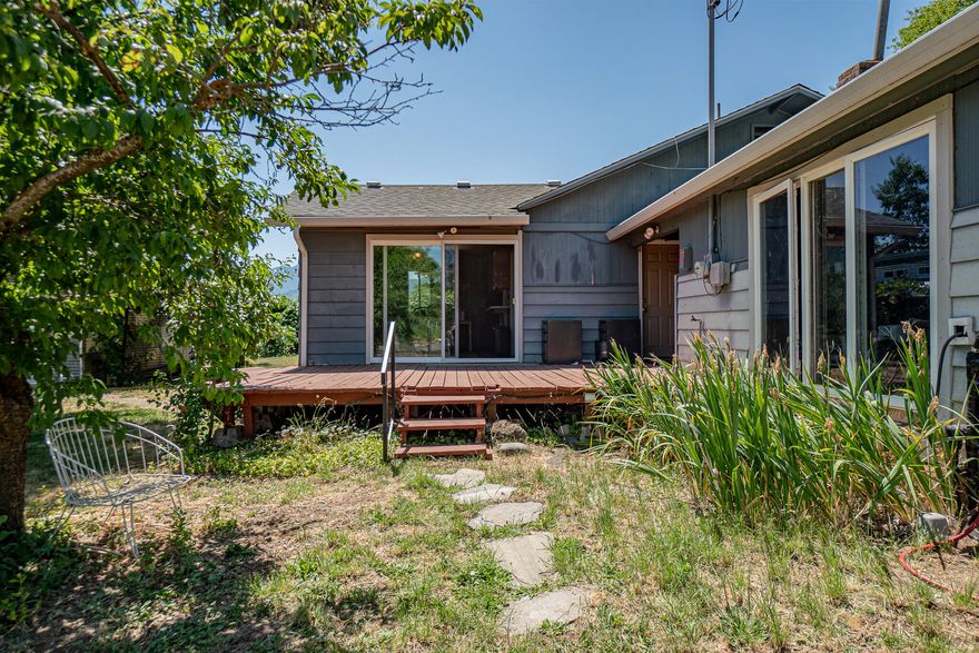 Hard to find close in mini ranch on a full acre ( two tax lots). .8 / acre of TID irrigation plus strong well and great soil. The ranch style home features oak floors, updated primary bathroom, large two car garage, natural gas heating, family room off the kitchen, plus extra detached living space , small solar installation. Easy access to both Medford and Ashland. Flat and useable acreage is perfect for those 4H projects. Nice views of the surrounding mountains and orchard and Grizzly Peak and Wagner Butte. Mostly fenced. Fireplace and more. The home is being sold in ''AS IS'' condition and the seller will only entertain full price offers.