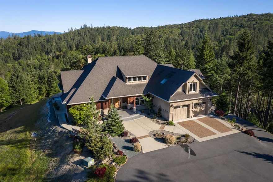 This is truly a jewel estate hidden on its own extremely private wooded hilltop, surrounded by BLM. Less than 5 miles from downtown Grants Pass, making this one of the most convenient and exclusive homes in the area. You'll love living and entertaining in this custom-built 3361 sq. ft. home on 77.8 private wooded acres. Walk into the main floor to open light and bright living area with beautiful views. Gourmet kitchen w/ large island, beautiful custom walnut cabinets and granite counters. Master suite has 2 walk-in closets w/ walk-in shower & soaking tub. 2nd bedroom currently being used as an office. Upstairs includes the spacious 3rd bedroom w/ ensuite and additional 1050 Sq. Ft. open bonus room perfect for just about anything. Downstairs 832 sq. ft. basement with single car garage door. Enjoy summer get-togethers on the covered terrace and inground pool with stunning sunsets. A 28x40 -2 car finished shop with attached carport. Seasonal creeks with pond and gated entrance!