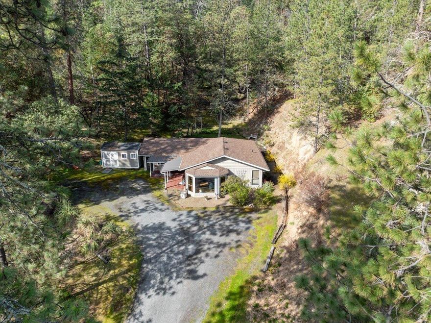 Privacy and views of Mt.Mcloughlin at this this cozy home situated between Central point and Jacksonville! The layout features 2 beds 1 bath and a garage conversion bonus room that could easily be a third bedroom. Kitchen and main-space flooring have been updated within the last few years.  This 5 acre hillside property features storage sheds at the top and bottom of the hill, as well as a ~25 foot parking space at the bottom for a boat or trailer. Come see it today! * listing agent is a relative of seller