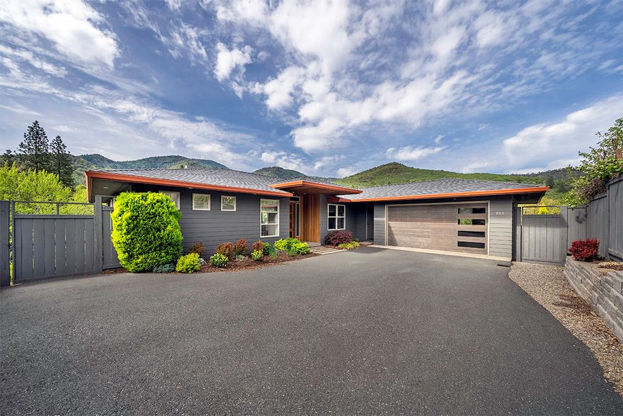 Gorgeous, architecturally designed contemporary home nestled in the hills of Ashland, Oregon. This modern 3 bed, 2.5 bath home is beautifully appointed w/luxury systems and upgrades throughout including hardwood floors, designer lighting and floor to ceiling glass doors. Main level master with private deck access, ceiling treatments, and a spa like ensuite featuring a dual sink vanity, walk-in shower, tile floors, and luxurious freestanding tub. Spacious kitchen open to the living room and dining area w/access to the expansive deck and outdoor areas. Huge center island w/eating bar, quartz countertops, Thermador 6 burner range w/double ovens, and a striking stainless-steel backsplash. Lower-level w/2 bedrooms, a bonus room, full bathroom, and family room.  Dedicated laundry/mud room, formal office area, and a 2-car garage with storage shelving and workbench. Oversized .26-acre lot with tons of privacy, mature easy-care landscaping, and fantastic views of the surrounding mountains!