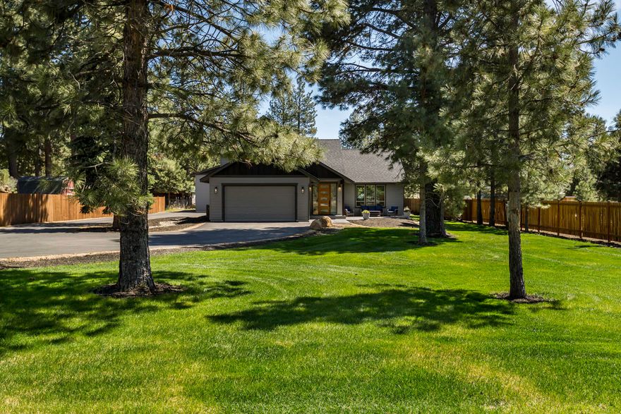 This exceptional 3-year-old custom-built home with a large shop and covered RV parking combines luxury, flexibility, and an ideal Bend location. Great possibilities  for multi-generational living or Airbnb w/ the vaulted flex room that includes quartz counters, sink, dishwasher, mini fridge, and microwave. The 3 bed/2.5 bath layout showcases walnut kitchen cabinetry,  pantry, quartz counters, vaulted open-concept living, and a stunning floor-to-ceiling stacked stone fireplace with inlaid walnut. European hardwood floors add warmth throughout. The primary suite features a tile shower and walk-in closet. Set on a fenced, landscaped 1-acre lot just minutes from Hwy 97, Brookswood Plaza, the Old Mill District, and downtown Bend. Outdoor living shines with a stamped concrete porch, large patio, hot tub, above-ground pool, and lush yard—a rare blend of country living close to town.