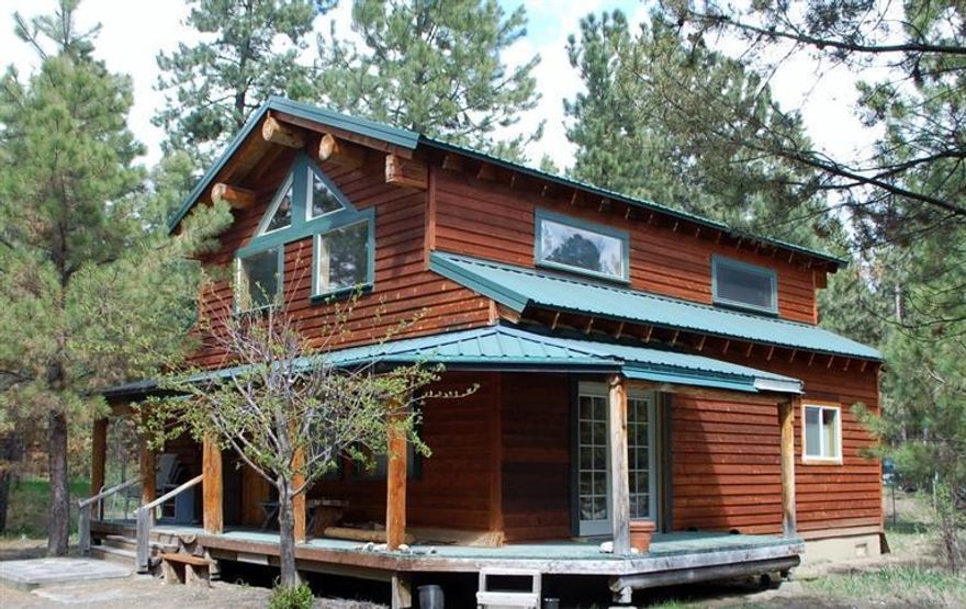 Great Cabin in the woods. Use as a getaway cabin or a primary residence. With some finishing touches, this home will shine. Loft area that can be used as an additional bedroom or office. 1/4 Mile from deeded river access for residents only. Cute outbuildings that look like an Old West downtown.