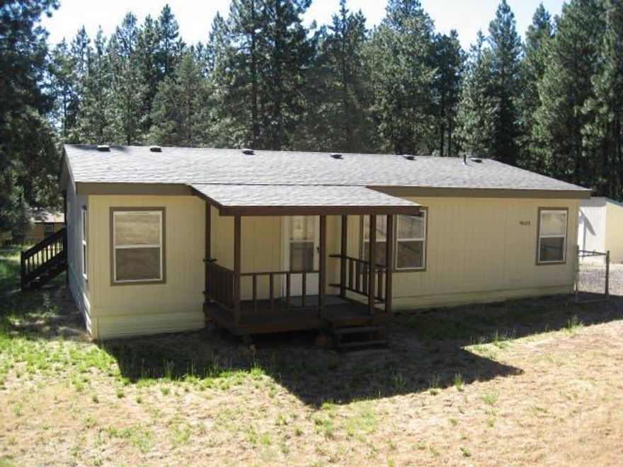 PRICE REDUCED! on this Like new home in the pines. Home has been recently updated thruout. Home has new roof, new flooring,newly painted on interior and exterior. Great floor plan with a large master bedroom with walk in closet. Large rear deck for enjoying the peaceful setting. The acreage is well timbered and is cross fenced. Very nice detached garage is 24' x 24' with a great shop area. There is also a covered storage behind garage of 10' x 24' suitable for hay storage etc. There is a small barn as well as a pump house. If you are looking for a home in like new condition located in a peaceful and convenient location this is the home for you.