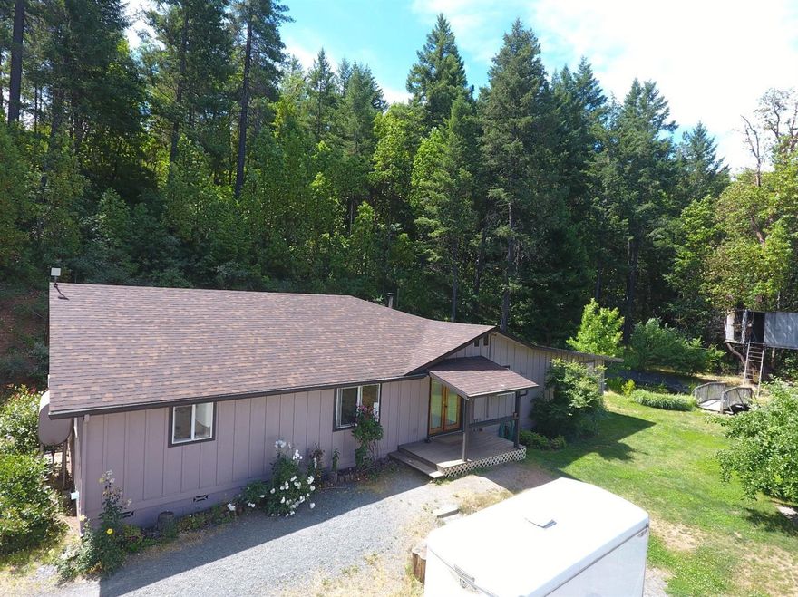 Time to relax at your tranquil mountain top retreat. All day sun and views from the garden. The last house on the road is the end-of-lane privacy you desire! Large 2,100 sq ft open floorplan. This 4 bedroom 2 bath home is shining; recent updates include fresh paint and flooring. Plenty of workshop for hobbies; this 3-Bay shop has a separate 200-amp power service (400-amp service total onsite). Only 3 miles from Cave Junction, but feels a private world away. Flowers, fruit trees, and automated Greenhouse for the green thumb. Koi Pond right off the back deck. Nursery equipment included. Owner May Carry